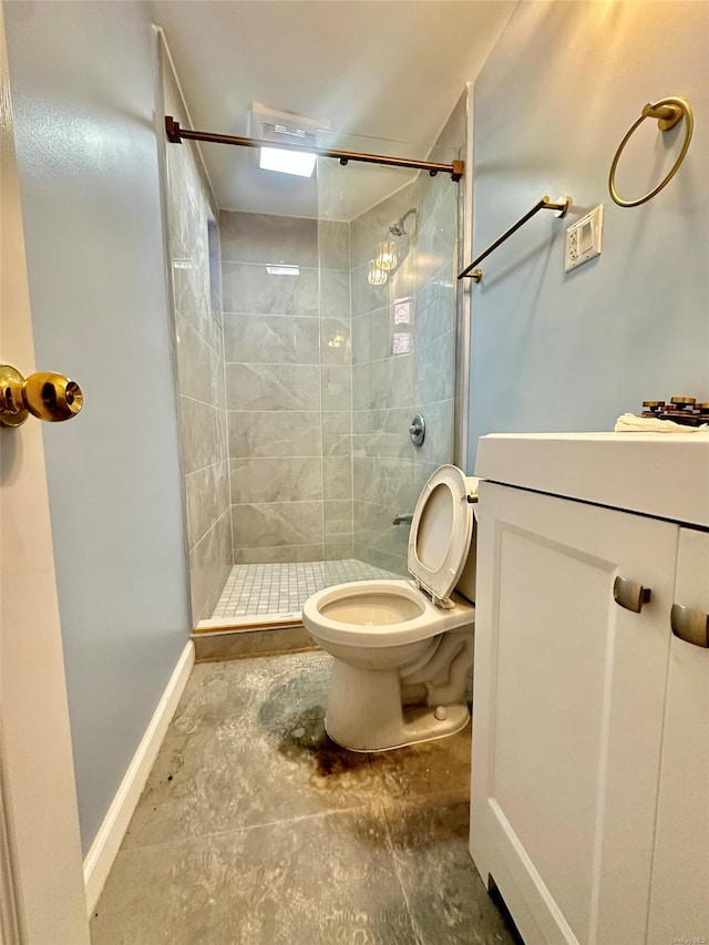 bathroom with a stall shower, baseboards, vanity, and toilet