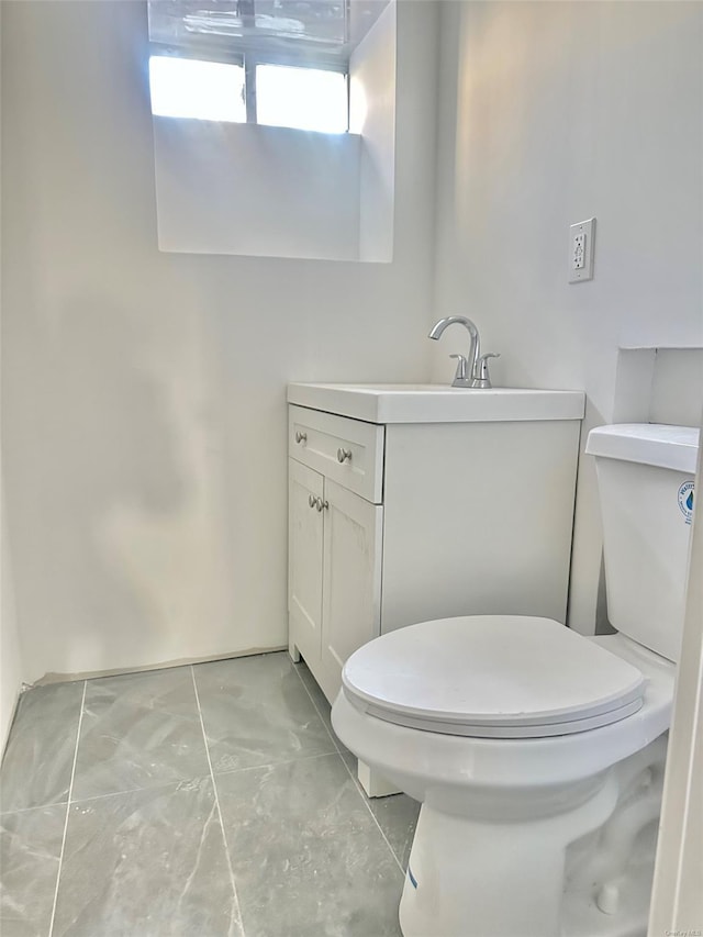 half bath featuring toilet and vanity