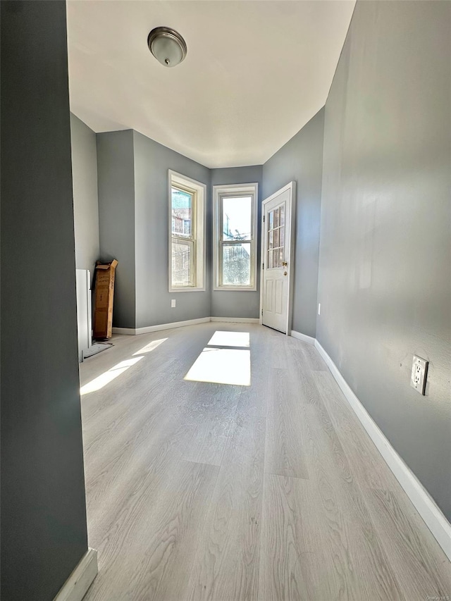 unfurnished room with wood finished floors and baseboards