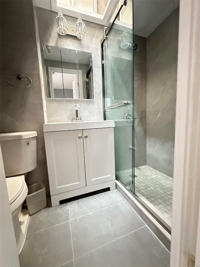 full bath with vanity, tile patterned flooring, a shower stall, and toilet