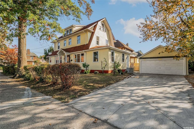 view of front of property with a garage and an outdoor structure