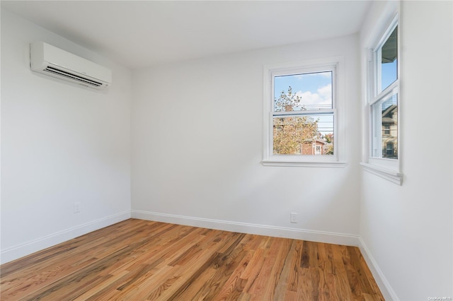 spare room with hardwood / wood-style flooring and a wall mounted AC