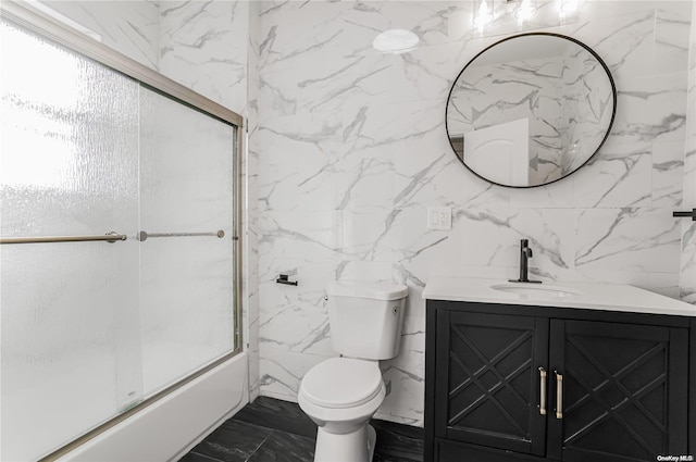 full bathroom with vanity, toilet, tile walls, and enclosed tub / shower combo