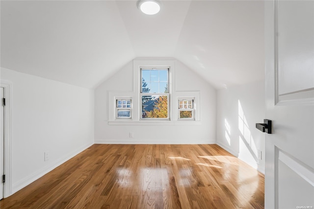 bonus room with light hardwood / wood-style flooring and vaulted ceiling