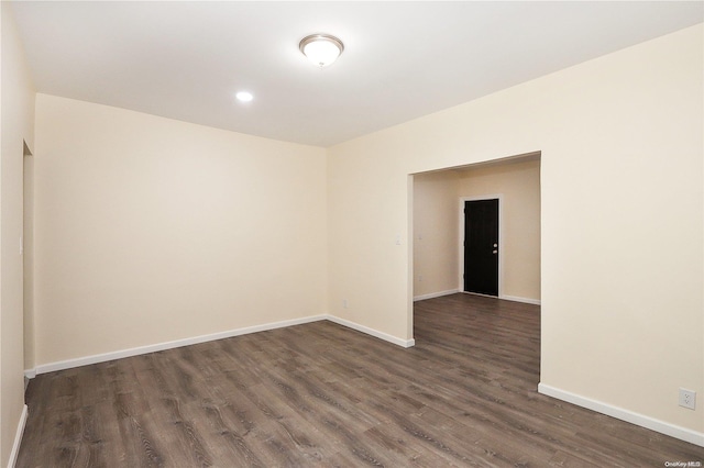 spare room featuring dark wood-type flooring