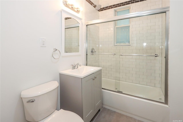 full bathroom featuring combined bath / shower with glass door, vanity, and toilet