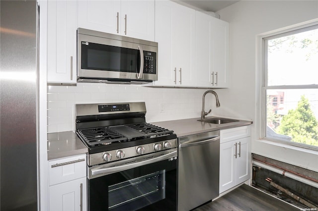 kitchen featuring white cabinetry, sink, dark wood-type flooring, and appliances with stainless steel finishes