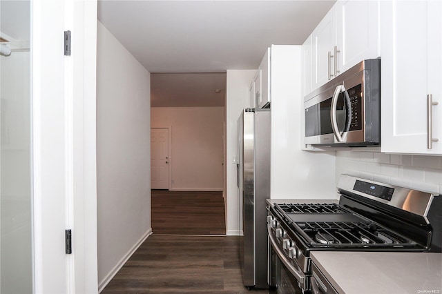 kitchen with white cabinets, appliances with stainless steel finishes, backsplash, and dark wood-type flooring