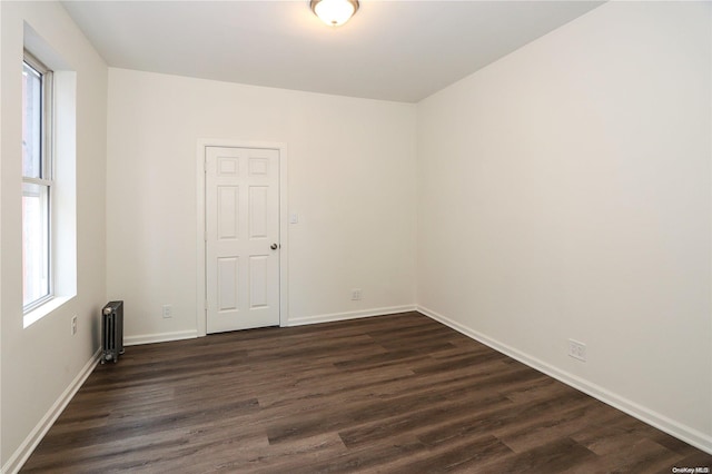 spare room with dark hardwood / wood-style flooring