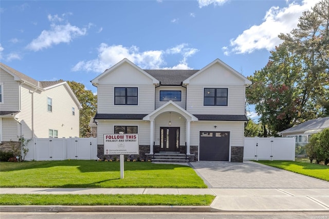 view of front of home with a garage and a front lawn