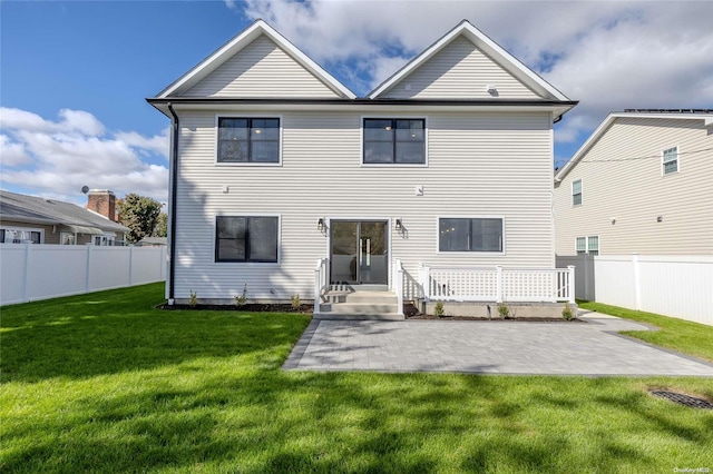 back of property featuring a yard and a patio