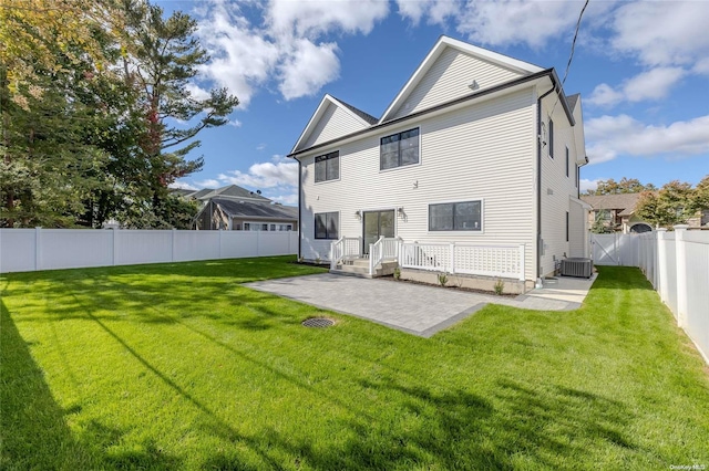 back of house with a yard, a patio, and central AC unit