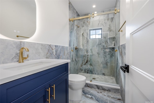 bathroom with vanity, toilet, walk in shower, and tile walls