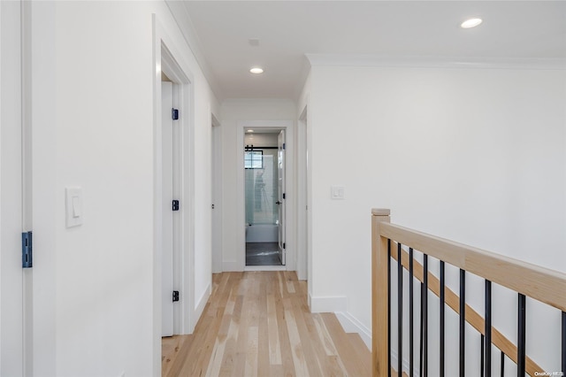 corridor featuring crown molding and light wood-type flooring