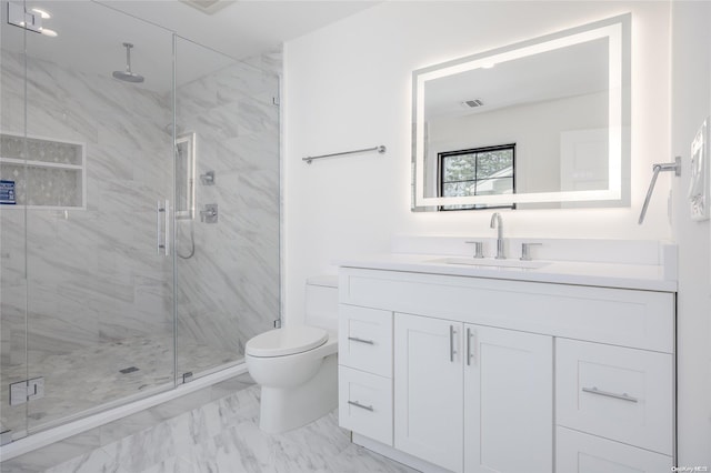 bathroom featuring vanity, toilet, and a shower with shower door