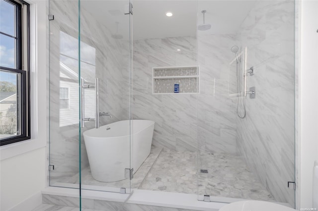 bathroom with separate shower and tub and a wealth of natural light