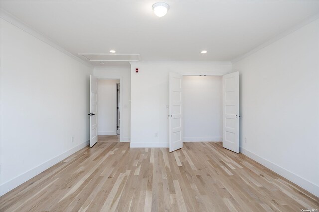 unfurnished bedroom with light hardwood / wood-style floors and crown molding