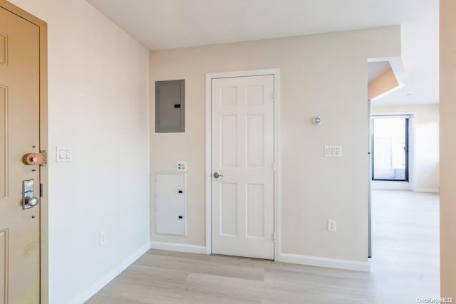 interior space featuring electric panel and light wood-type flooring