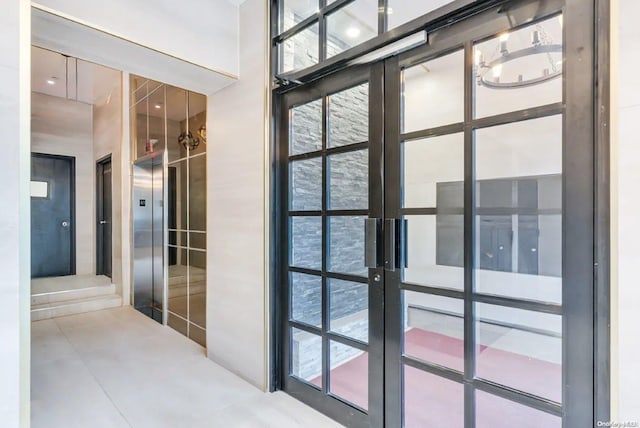 doorway with elevator and french doors