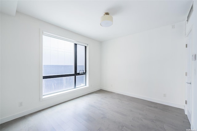 unfurnished room with light hardwood / wood-style flooring