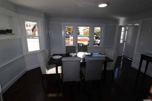 dining area with a wealth of natural light and dark hardwood / wood-style flooring