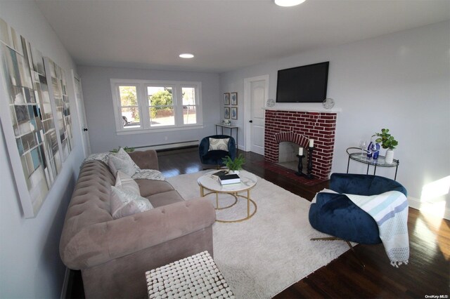 living room with baseboard heating, a fireplace, and hardwood / wood-style flooring