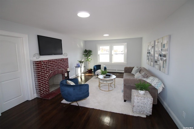 living room with a fireplace, wood-type flooring, and baseboard heating