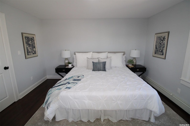 bedroom featuring dark hardwood / wood-style flooring and a baseboard heating unit