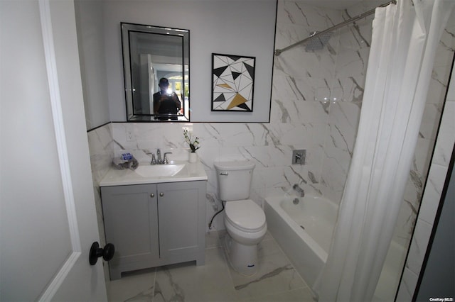 full bathroom with vanity, toilet, tile walls, and shower / tub combo