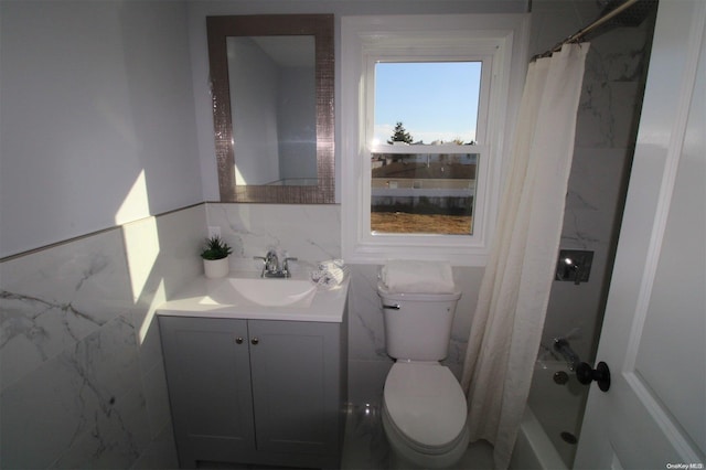 bathroom featuring vanity, tile walls, and toilet