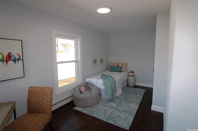 bedroom featuring dark wood-type flooring and a baseboard radiator