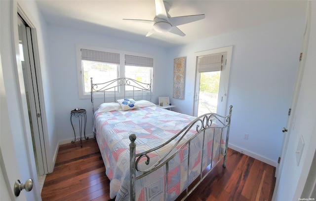 bedroom with multiple windows, ceiling fan, dark hardwood / wood-style flooring, and access to exterior