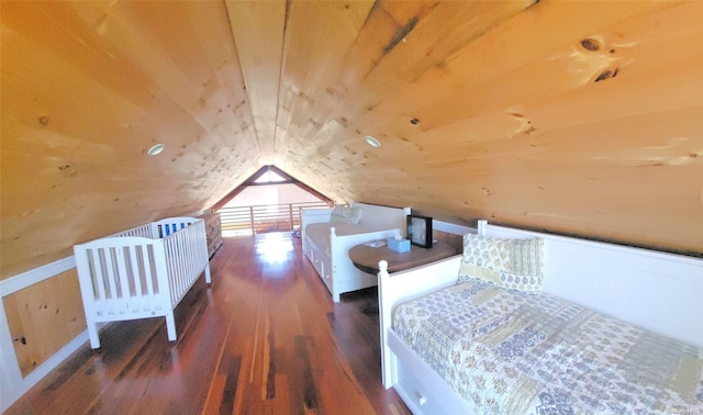 bedroom featuring wood walls, dark hardwood / wood-style flooring, and lofted ceiling