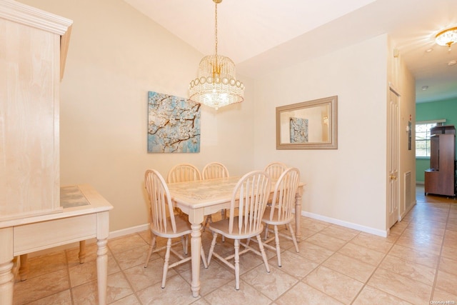 dining area with lofted ceiling and a notable chandelier