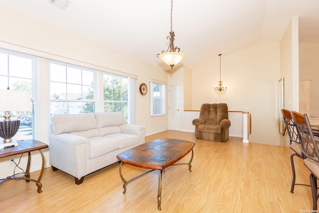 living room featuring light wood-type flooring and vaulted ceiling