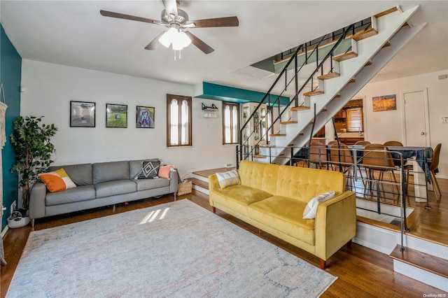 living room with dark hardwood / wood-style floors and ceiling fan