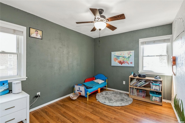 bedroom featuring light hardwood / wood-style floors and ceiling fan