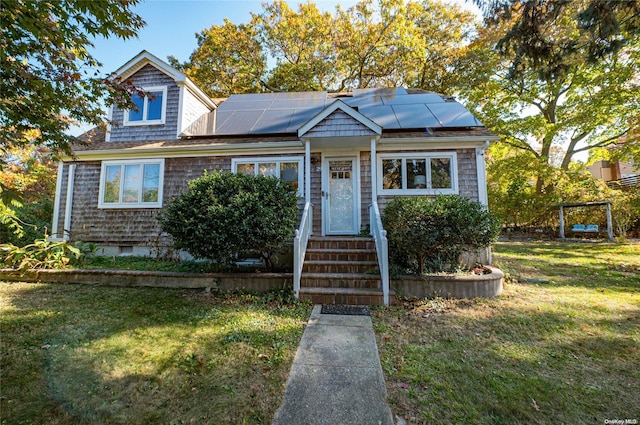 bungalow featuring solar panels and a front yard