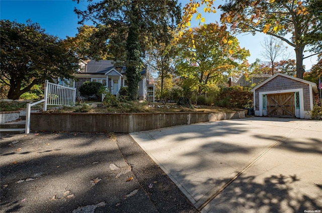 view of property exterior with a garage and an outdoor structure