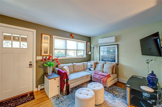 living room featuring light hardwood / wood-style floors, an AC wall unit, and a baseboard heating unit