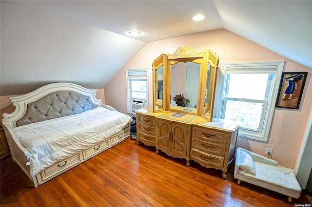 bedroom featuring hardwood / wood-style floors, cooling unit, and vaulted ceiling