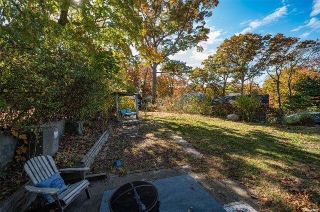 view of yard with a patio area and an outdoor fire pit