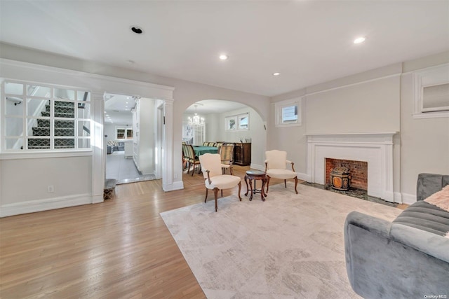 living room featuring an inviting chandelier and light hardwood / wood-style flooring