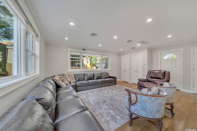 living room with light hardwood / wood-style floors and ornamental molding