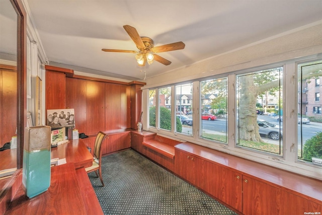 unfurnished sunroom with ceiling fan