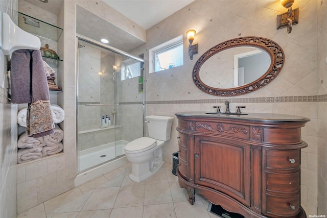 bathroom with walk in shower, tile patterned flooring, toilet, vanity, and tile walls