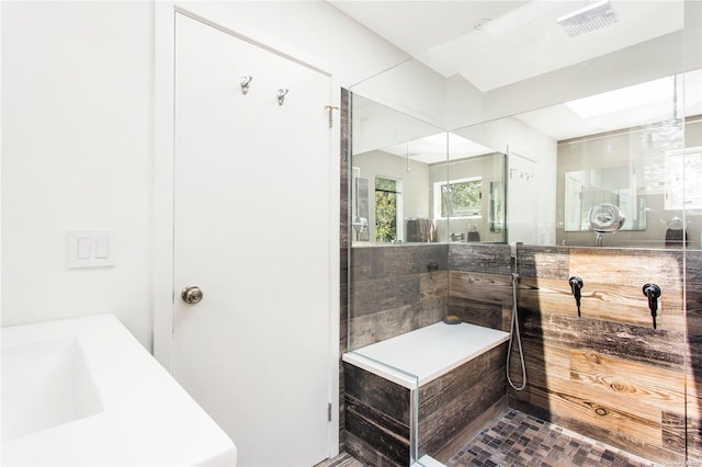 bathroom with tile patterned floors, vanity, and tiled shower