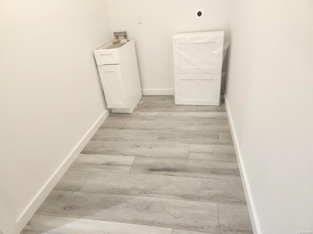 hallway with light hardwood / wood-style flooring