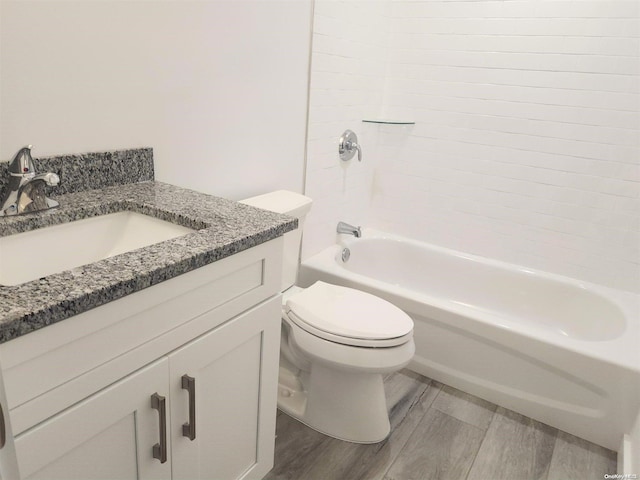 full bathroom with hardwood / wood-style flooring, shower / bathtub combination, vanity, and toilet