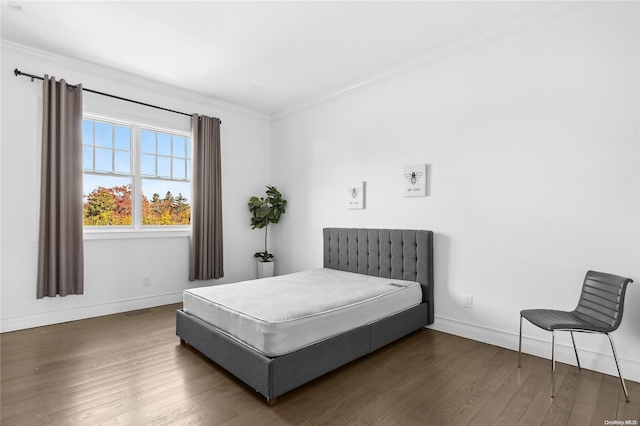 bedroom with dark hardwood / wood-style floors and crown molding